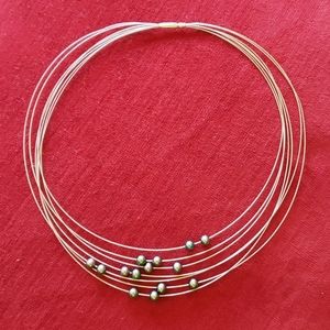 14 karat gold floating  black Pearl necklace